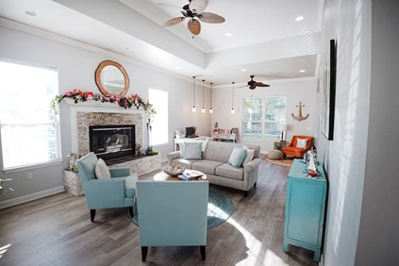 a living room with couches and chairs and a fireplace