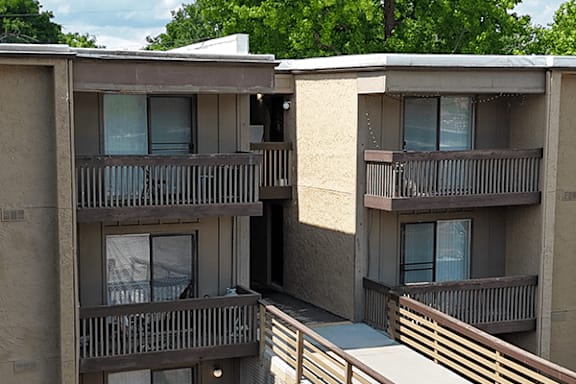 Apartment complex with balconies and doors.