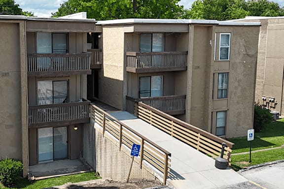 Apartment complex with a blue handicap sign in front.