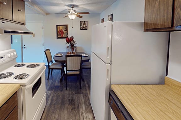 A kitchen with a table and chairs in the middle of it.