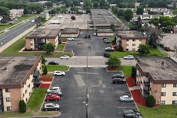 A parking lot in front of apartment buildings.