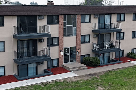 Apartment building with balconies and doors.