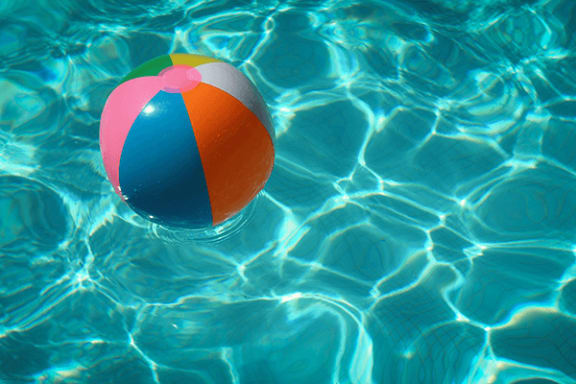 a colorful beach ball floating in a pool
