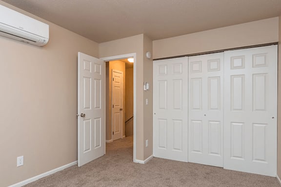 A room with a white door and a white wall.