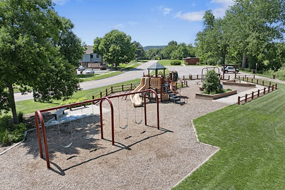 A playground with a swing set and a slide.