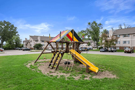 a swing set in the middle of a yard