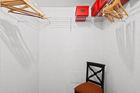 a white room with a chair and a rack on the wall