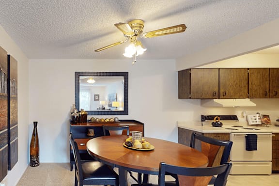 A dining room with a table set for four.