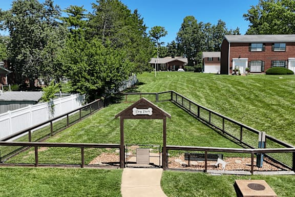 A small wooden sign with the word "Welcome" is in the middle of a grassy area.