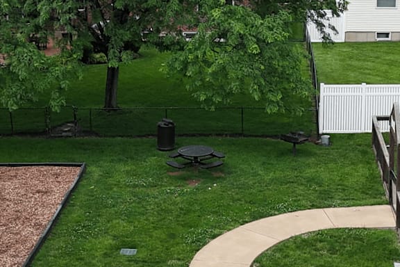 A backyard with a fire pit and a fence.