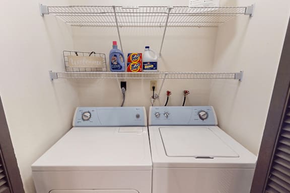 A small laundry room with a washer and dryer.