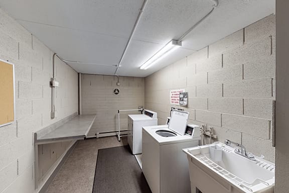 A bathroom with a toilet, sink, and mirror.