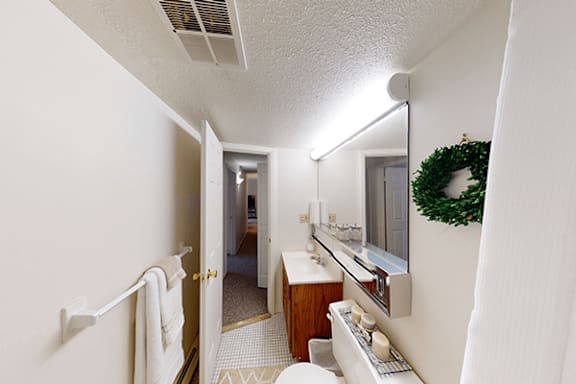 A bathroom with a white towel hanging on the wall.