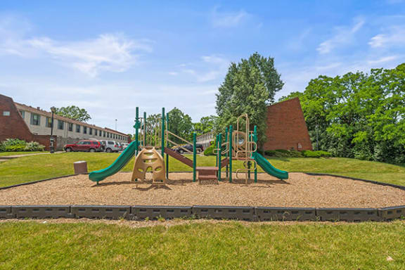 a playground in a park next to a building