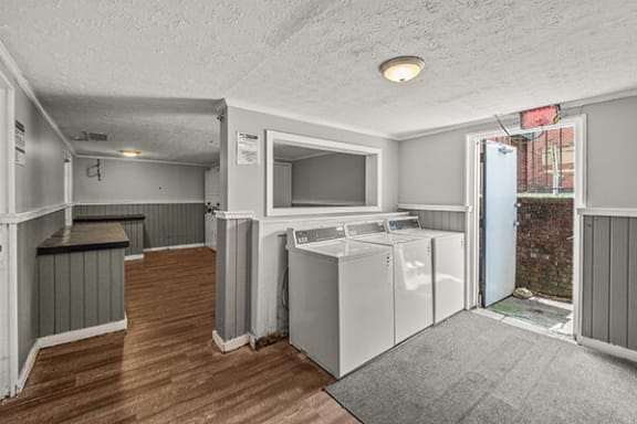 an empty kitchen with a refrigerator and a sink