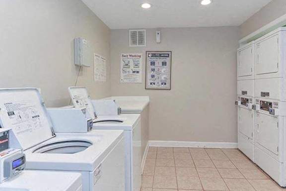 a laundry room with four washing machines