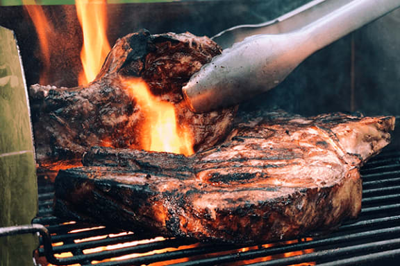 a steak being grilled on a grill