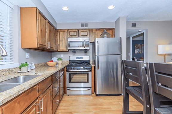 a kitchen with stainless steel appliances and wooden cabinets