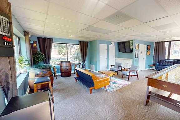 A living room with a blue couch and a wooden coffee table.