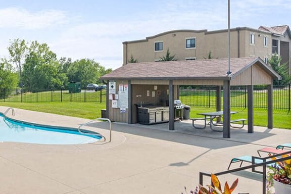 a swimming pool with a pavilion next to a building