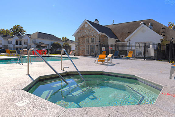 A small pool with a diving board in the middle of a courtyard.