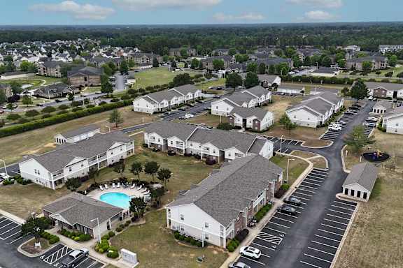 A bird's eye view of a residential complex with a swimming pool.
