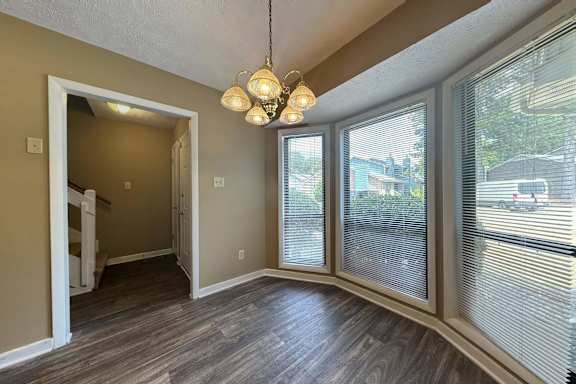 A room with a brown floor and a white door.