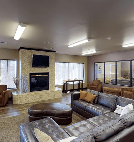 a living room with couches and a fireplace