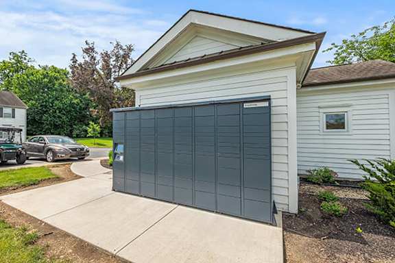 A white house with a grey garage door.