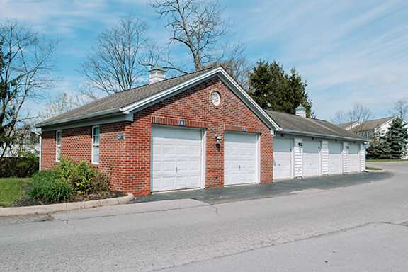 A red brick house with a white garage door.