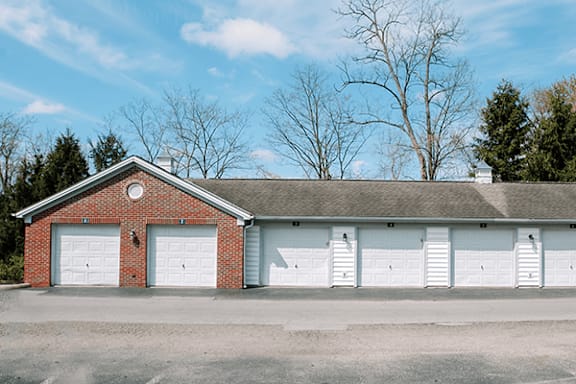 A red brick building with white garage doors.
