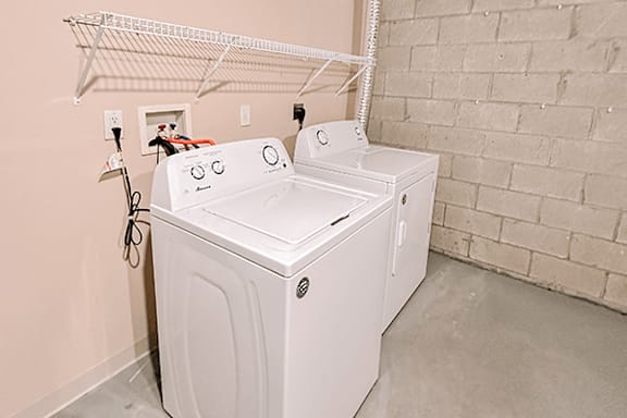 A white washing machine in a laundry room.