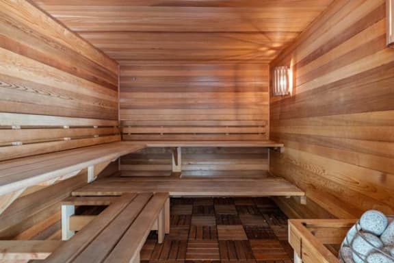 a sauna with a wooden floor and benches