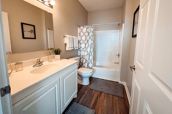 A bathroom with a white sink and toilet.
