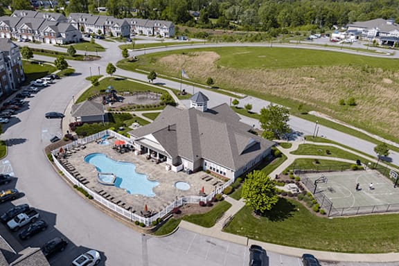A large building with a pool in front of it.