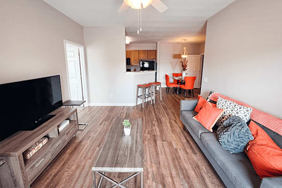 A living room with a grey couch and a wooden coffee table.