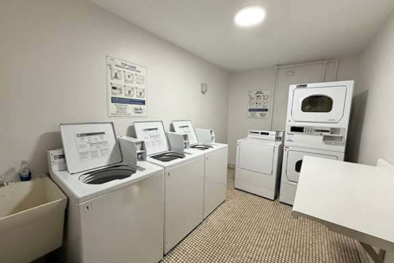 A laundry room with washers and dryers.