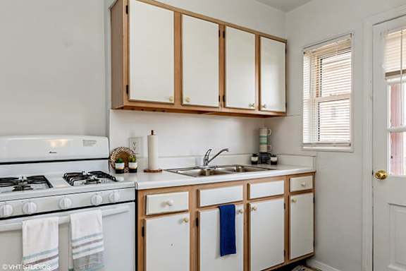 a kitchen with white appliances and wooden cabinets