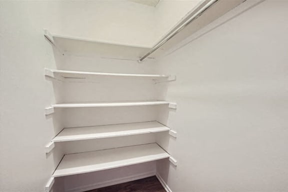 a white closet with empty shelves in it