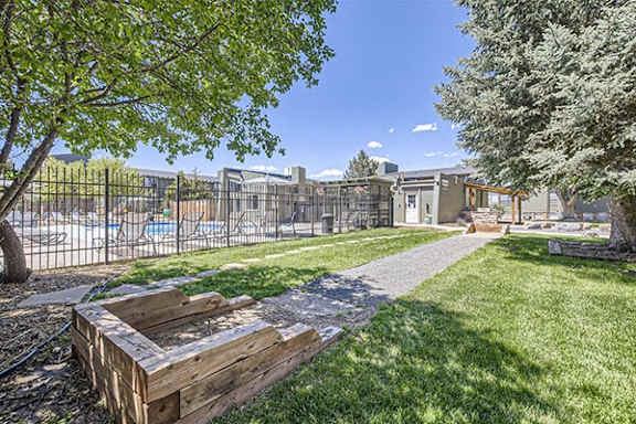 a yard with a picnic table and a fence
