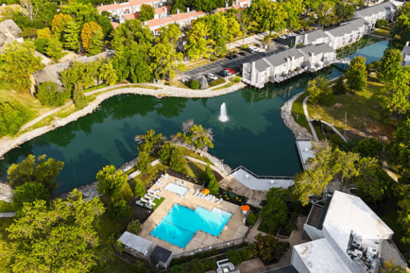 an aerial view of the pool and lake at the resort