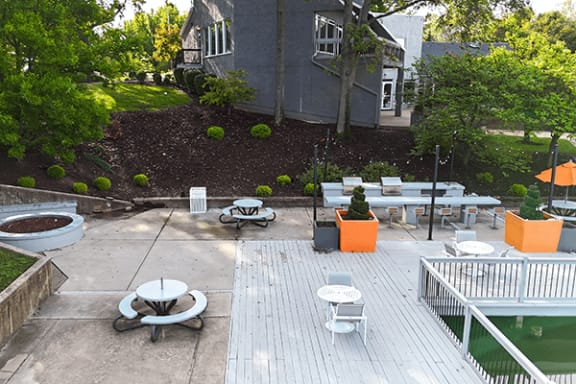 a backyard with tables and chairs and a pool and a house