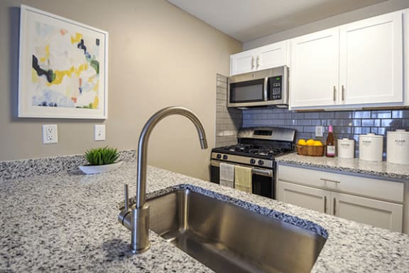 a kitchen with granite counter tops and stainless steel appliances