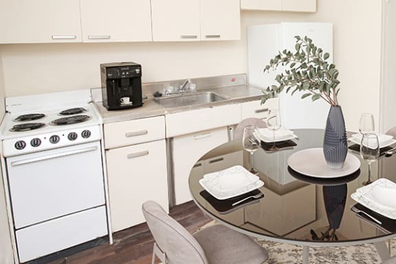 a kitchen and dining room with a glass table