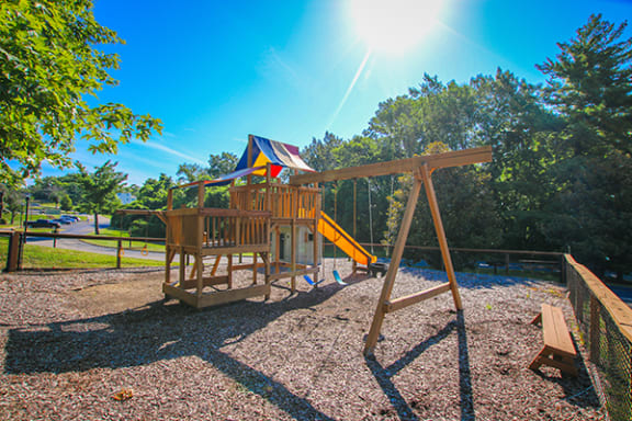 a playground with a swing set and a slide