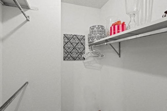 a bathroom with a shelf on the wall