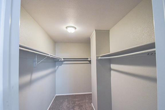 a walk in closet in an empty basement room