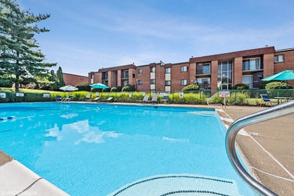 a large swimming pool with a building in the background