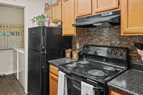 a kitchen with a stove and a refrigerator