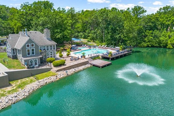 a large backyard with a pool and a water fountain